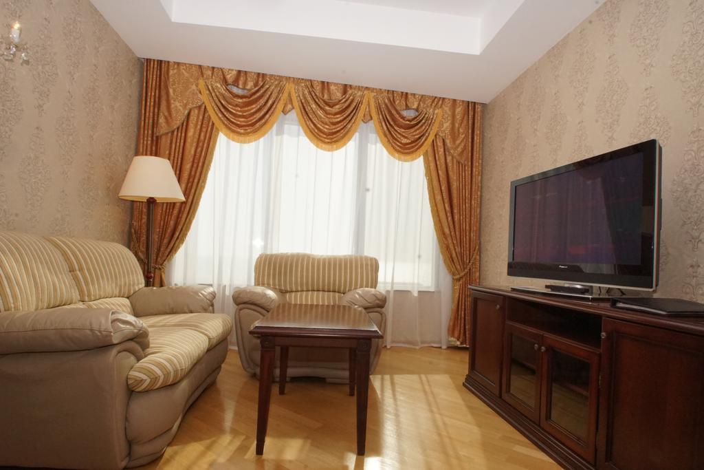 Grand Hotel Victory Aktau  Eksteriør billede A living room with a television